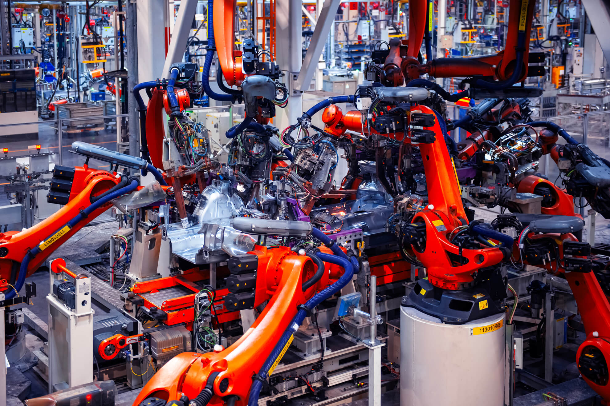 Automotive assembly line where precision-formed tubing and components are installed.